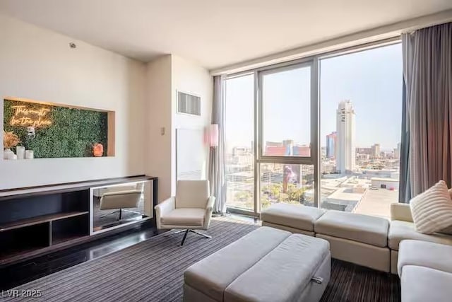 living room featuring visible vents and floor to ceiling windows