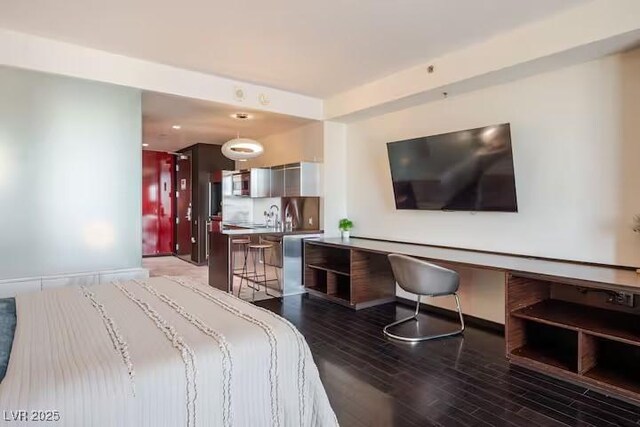 bedroom featuring wood finished floors and baseboards