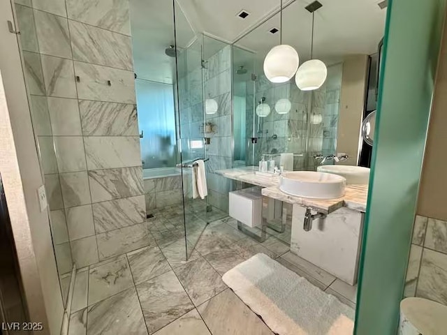 full bathroom featuring a shower stall, marble finish floor, and tile walls