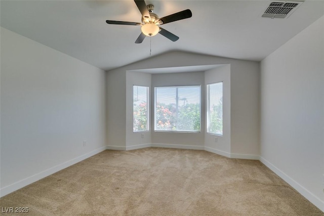 empty room with baseboards, visible vents, and light colored carpet