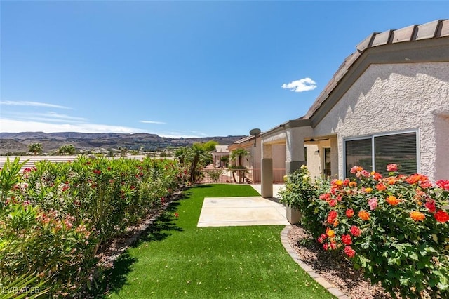 view of yard featuring a mountain view and a patio