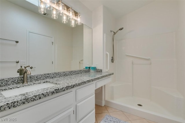 bathroom featuring a shower, vanity, and tile patterned flooring