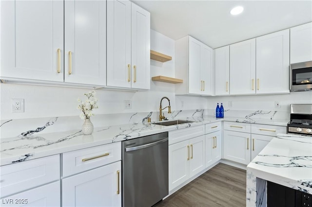 kitchen with stainless steel appliances, open shelves, white cabinets, and a sink