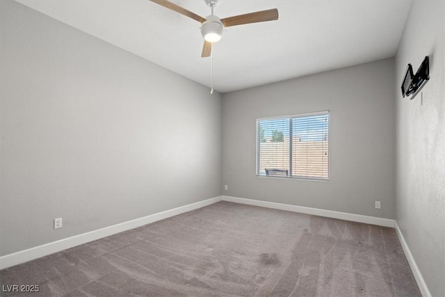 carpeted empty room with baseboards and a ceiling fan