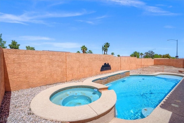 view of swimming pool featuring a fenced backyard and a pool with connected hot tub