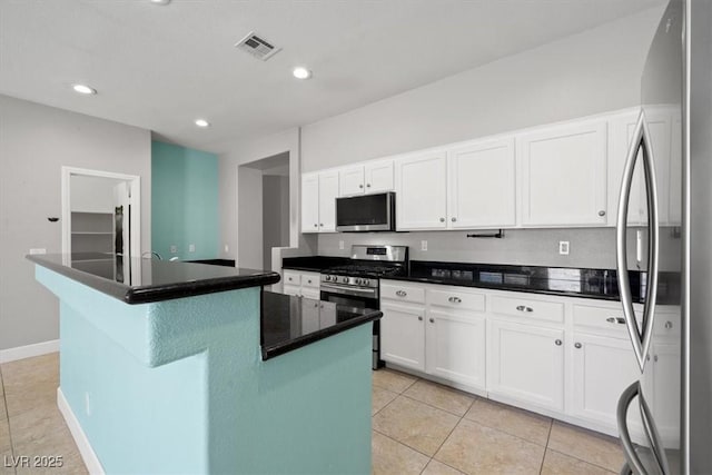 kitchen featuring stainless steel appliances, visible vents, white cabinetry, and light tile patterned floors