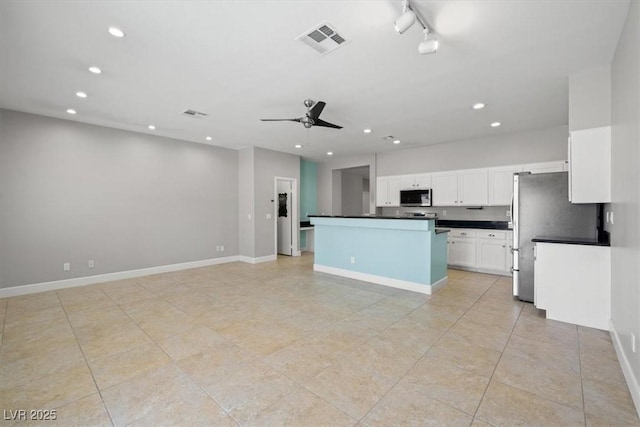 kitchen featuring visible vents, dark countertops, recessed lighting, white cabinetry, and appliances with stainless steel finishes