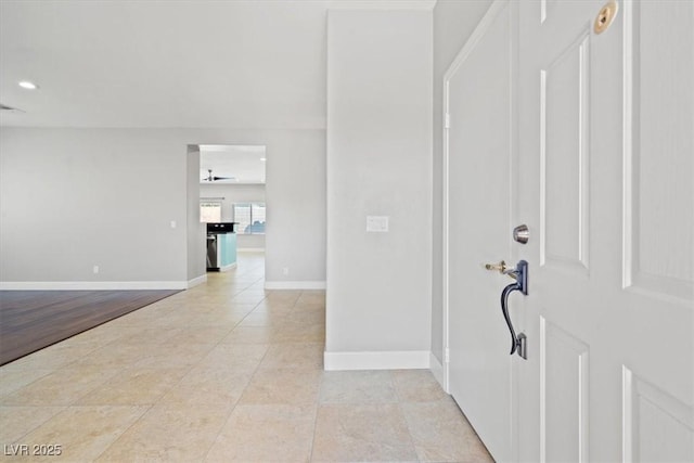 foyer featuring light tile patterned floors, baseboards, and recessed lighting