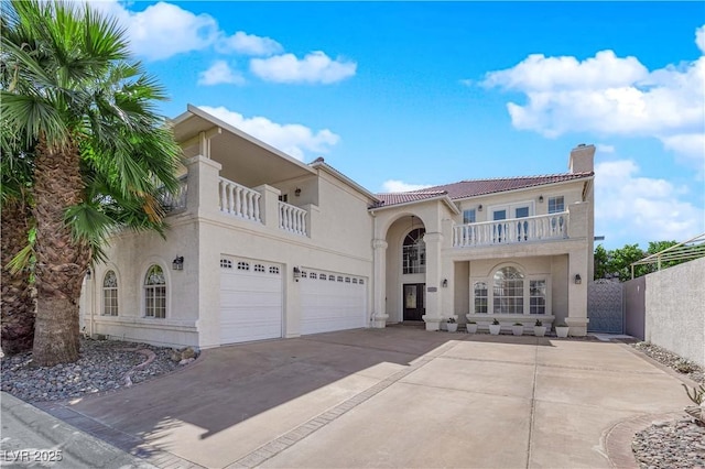 2595 Aviv Ct, Las Vegas, NV 89121 - mediterranean / spanish-style house with a chimney, stucco siding, fence, a balcony, and concrete driveway