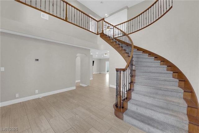 2595 Aviv Ct, Las Vegas, NV 89121 - stairs with recessed lighting, arched walkways, baseboards, visible vents, and a high ceiling