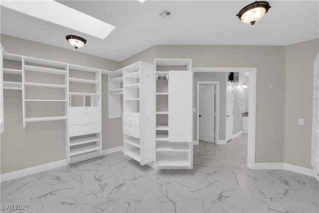 2595 Aviv Ct, Las Vegas, NV 89121 - walk in closet featuring visible vents, marble finish floor, and a skylight