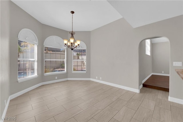 2595 Aviv Ct, Las Vegas, NV 89121 - spare room with a chandelier, baseboards, and arched walkways