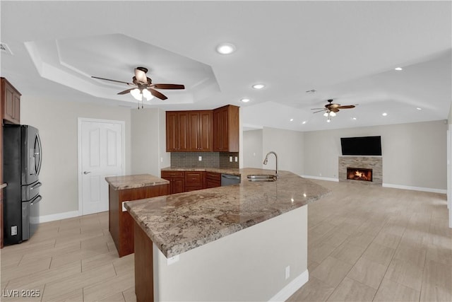 2595 Aviv Ct, Las Vegas, NV 89121 - kitchen with a sink, stainless steel appliances, ceiling fan, a raised ceiling, and a center island