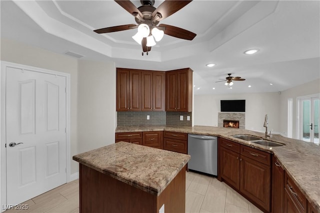 2595 Aviv Ct, Las Vegas, NV 89121 - kitchen with recessed lighting, stainless steel dishwasher, a sink, a raised ceiling, and a ceiling fan