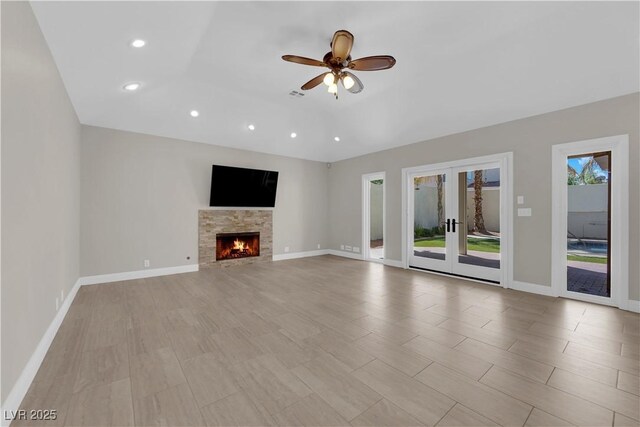 2595 Aviv Ct, Las Vegas, NV 89121 - unfurnished living room featuring a ceiling fan, recessed lighting, french doors, and a fireplace