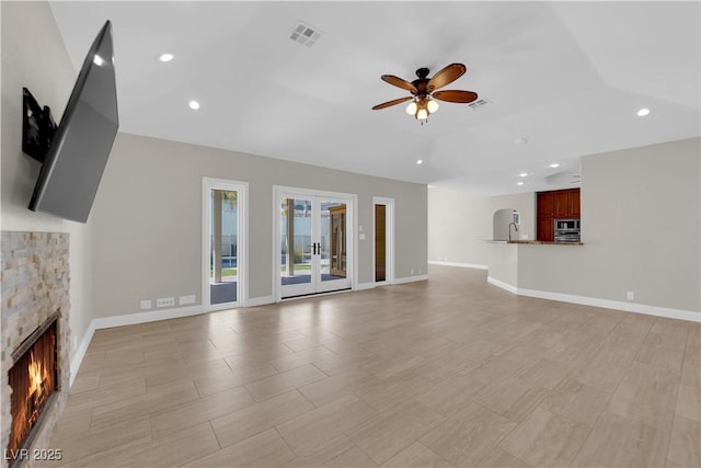 2595 Aviv Ct, Las Vegas, NV 89121 - unfurnished living room with visible vents, baseboards, recessed lighting, a ceiling fan, and a stone fireplace