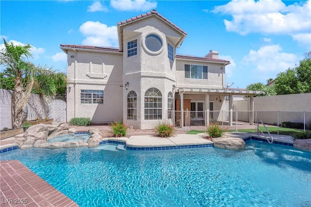 2595 Aviv Ct, Las Vegas, NV 89121 - back of property with a chimney, stucco siding, a fenced in pool, an in ground hot tub, and a patio area