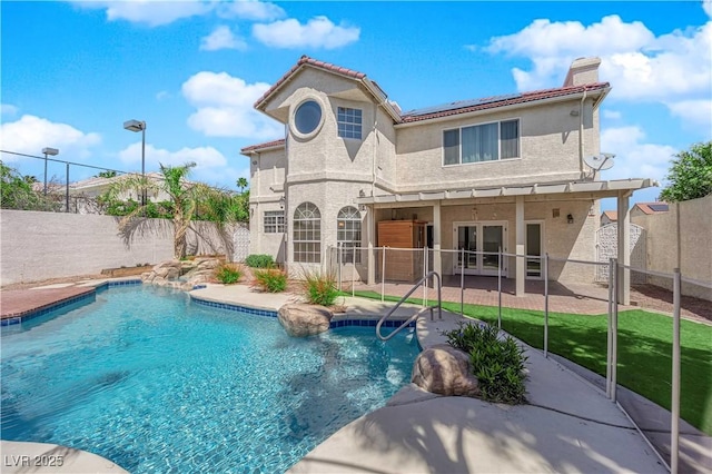 2595 Aviv Ct, Las Vegas, NV 89121 - rear view of property featuring french doors, a chimney, a patio, a fenced backyard, and stucco siding