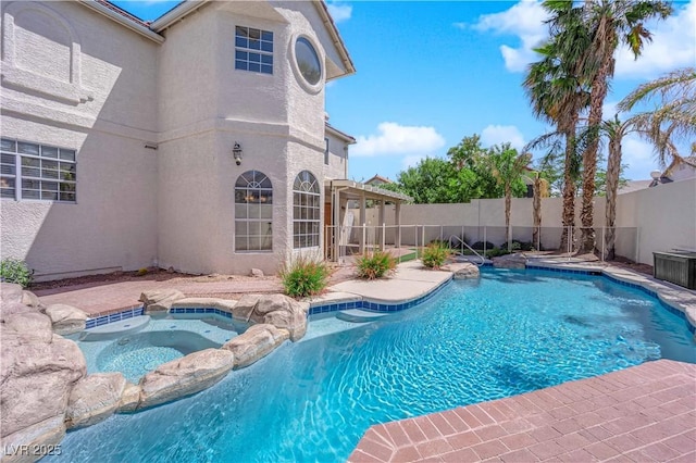 2595 Aviv Ct, Las Vegas, NV 89121 - view of pool featuring a pool with connected hot tub, a patio, and a fenced backyard