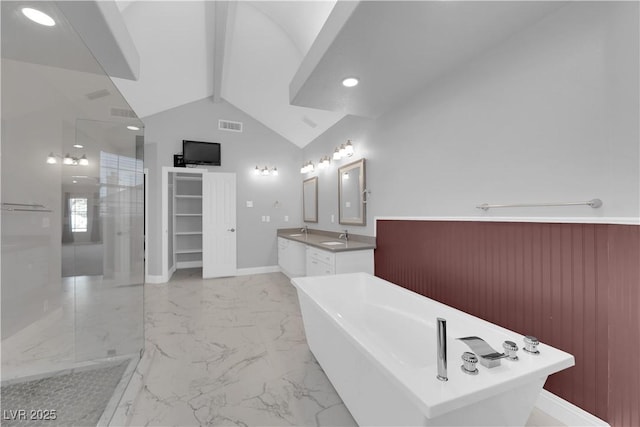 2595 Aviv Ct, Las Vegas, NV 89121 - bathroom with a sink, lofted ceiling with beams, marble finish floor, a freestanding bath, and visible vents