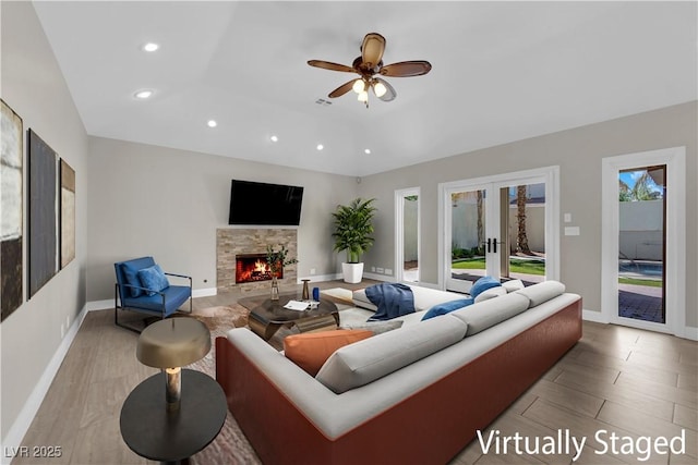 2595 Aviv Ct, Las Vegas, NV 89121 - living area with recessed lighting, ceiling fan, a stone fireplace, and french doors