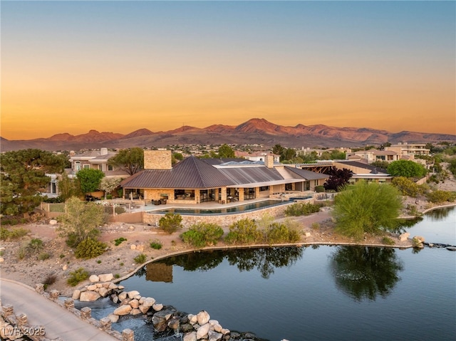 aerial view at dusk with a water and mountain view