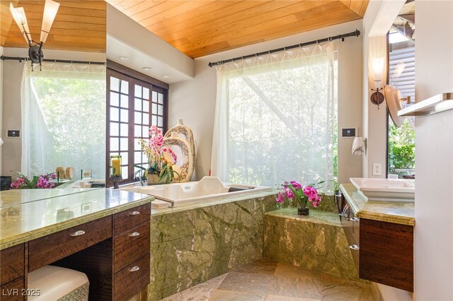 bathroom featuring wood ceiling, stone finish floor, a bath, french doors, and vanity
