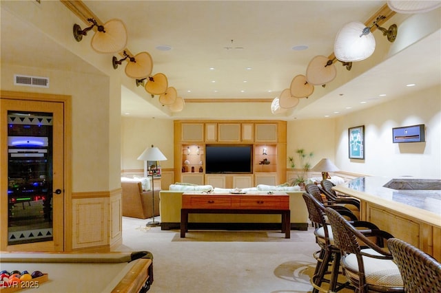 living area with visible vents, recessed lighting, wainscoting, and light carpet
