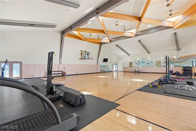 workout area featuring high vaulted ceiling, community basketball court, and wood finished floors
