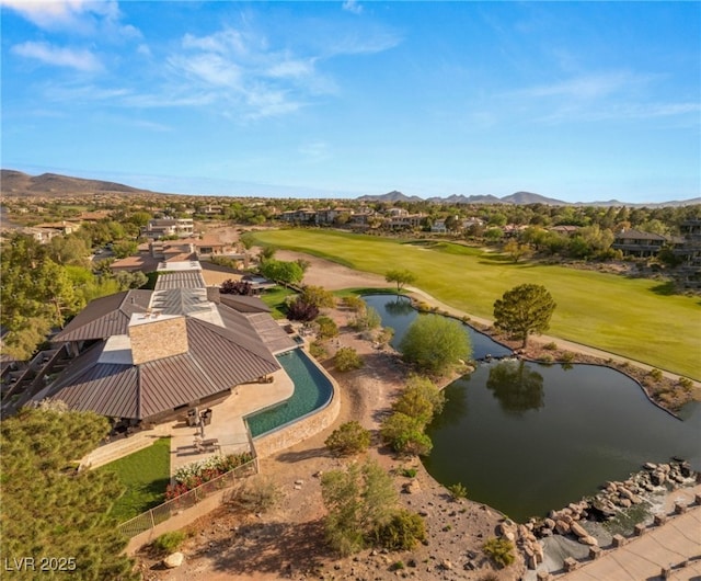 drone / aerial view with a residential view, a water and mountain view, and view of golf course