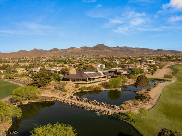 birds eye view of property featuring a residential view, view of golf course, and a water and mountain view