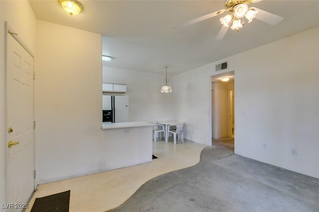 living room with ceiling fan, light carpet, and visible vents