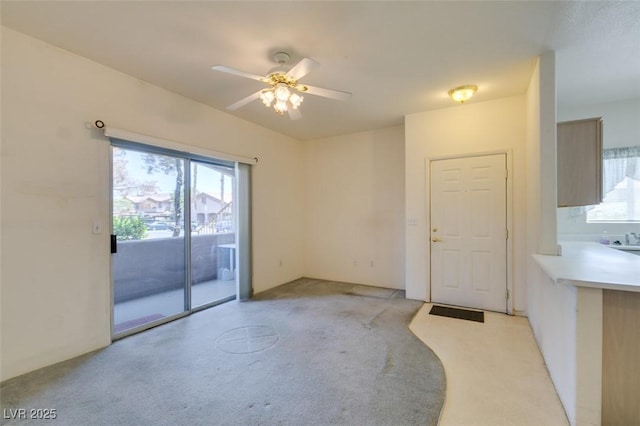 5751 E Hacienda Ave Unit 105, Las Vegas, NV 89122 - empty room featuring light colored carpet, a ceiling fan, and a sink