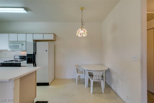 5751 E Hacienda Ave Unit 105, Las Vegas, NV 89122 - kitchen with white appliances, light flooring, light countertops, pendant lighting, and white cabinetry