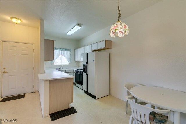 kitchen featuring white refrigerator with ice dispenser, light countertops, a sink, light floors, and gas range oven