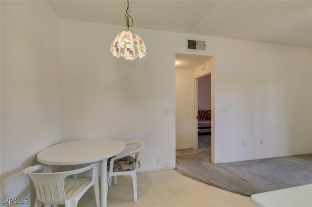 dining room featuring carpet floors, tile patterned floors, and visible vents
