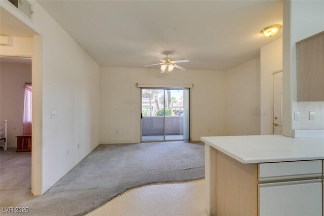 5751 E Hacienda Ave Unit 105, Las Vegas, NV 89122 - unfurnished living room featuring light colored carpet and ceiling fan