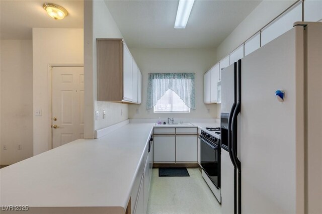 5751 E Hacienda Ave Unit 105, Las Vegas, NV 89122 - kitchen with white appliances, a sink, a peninsula, light countertops, and white cabinetry