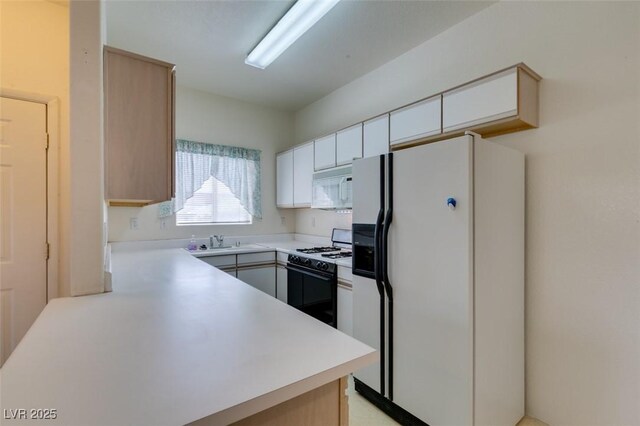 5751 E Hacienda Ave Unit 105, Las Vegas, NV 89122 - kitchen featuring white appliances, a sink, light countertops, and white cabinets