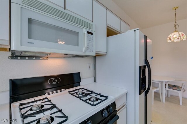5751 E Hacienda Ave Unit 105, Las Vegas, NV 89122 - kitchen featuring white appliances, white cabinets, light countertops, and decorative light fixtures
