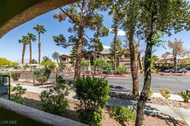 surrounding community featuring fence and a residential view