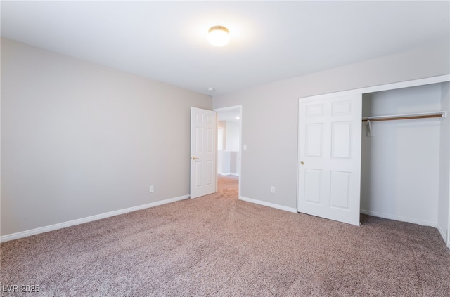 unfurnished bedroom with baseboards, carpet, and a closet