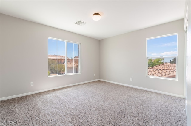 carpeted spare room with baseboards and visible vents