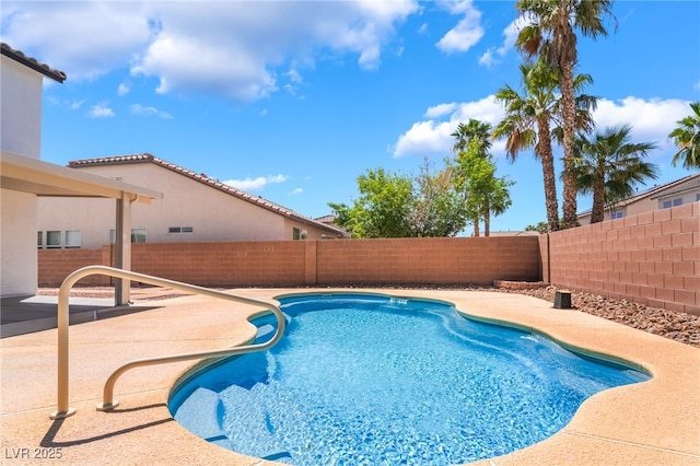 view of swimming pool with a fenced backyard, a fenced in pool, and a patio area