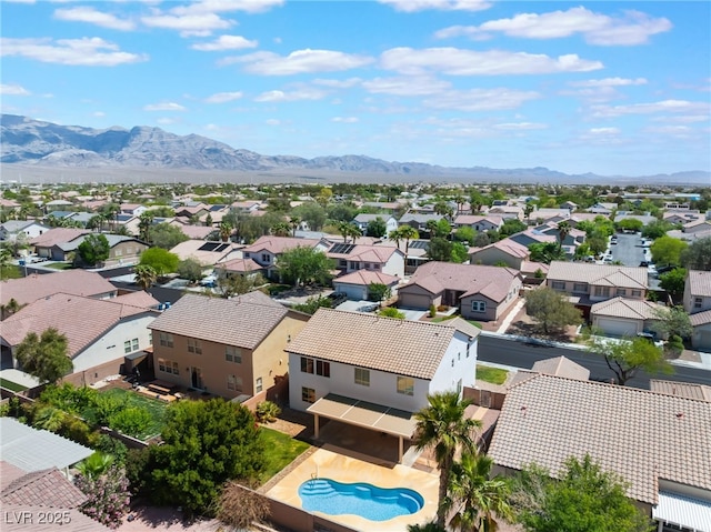 drone / aerial view featuring a residential view and a mountain view