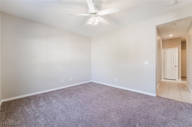 empty room featuring baseboards, a ceiling fan, lofted ceiling, and light colored carpet