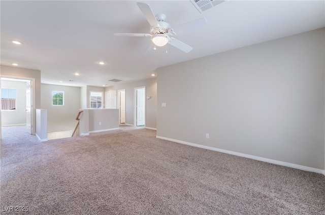 unfurnished room featuring recessed lighting, baseboards, visible vents, and light carpet