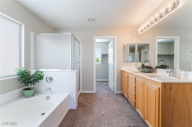 bathroom with double vanity, a shower stall, a sink, and a bath