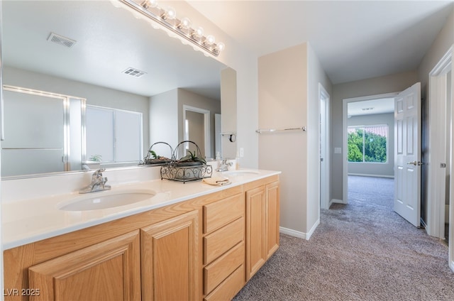 full bathroom featuring a sink, double vanity, and visible vents