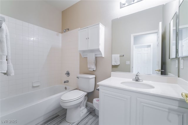 bathroom featuring shower / bath combination, vanity, and toilet